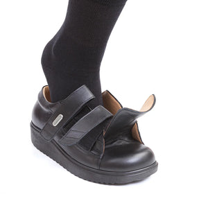 Model demonstrating extra wide medical shoes by TDO, ideal for swollen feet and diabetic foot care.