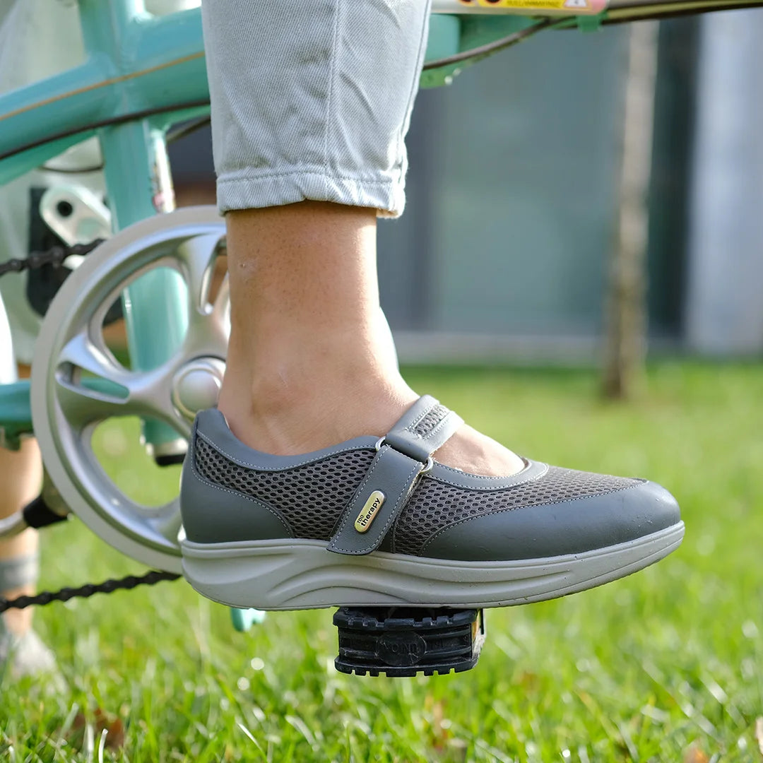  Active woman wearing comfortable orthopedic rocker shoes by TDO, supporting foot health with wide fit design.