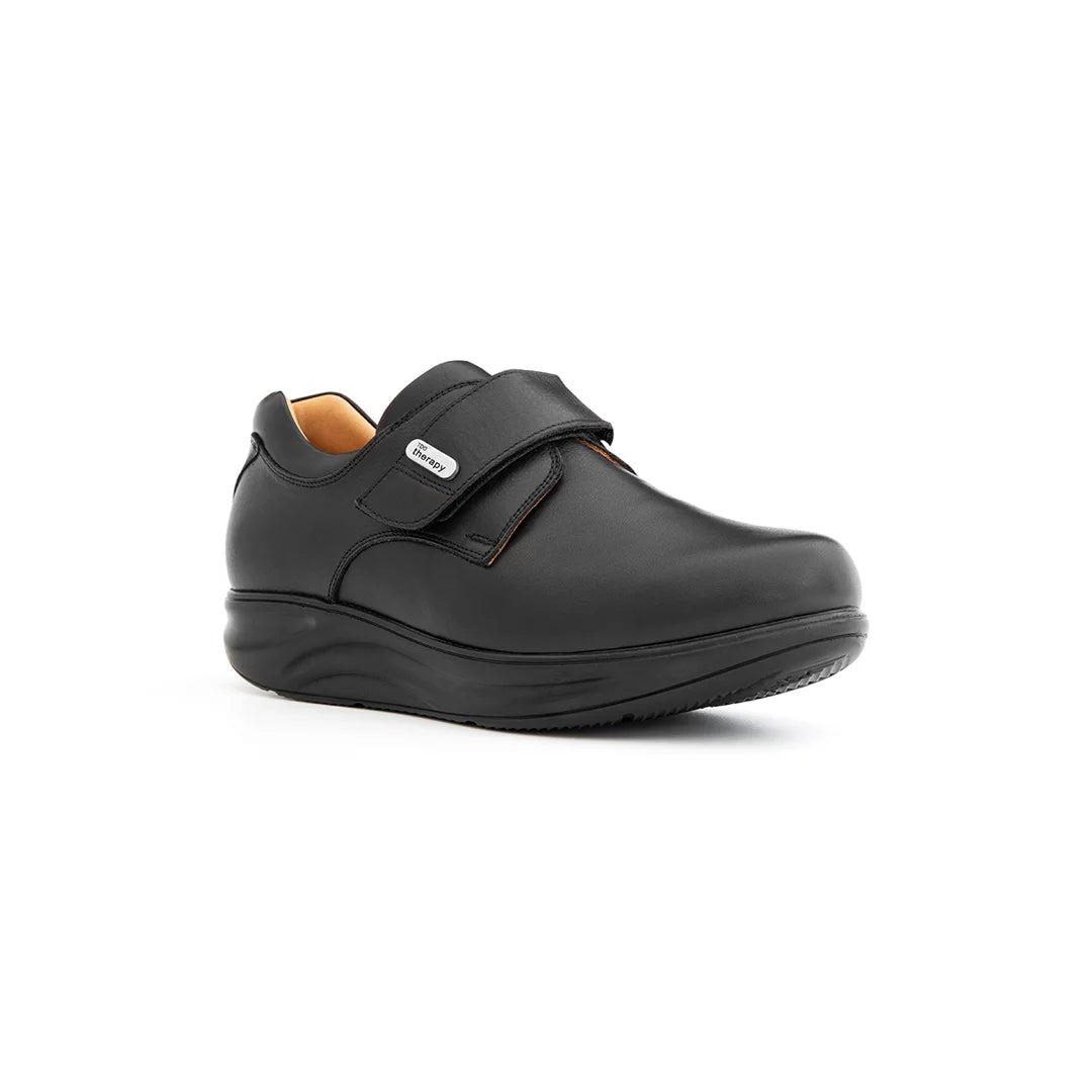 Orthopedic shoe with rocker bottom, velcro closure, and seamless liner for comfort.